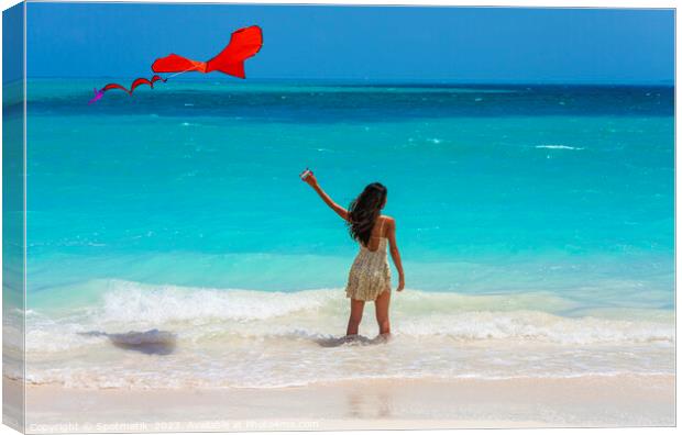 Asian girl standing in ocean waves flying kite Canvas Print by Spotmatik 