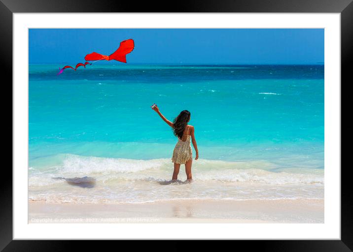 Asian girl standing in ocean waves flying kite Framed Mounted Print by Spotmatik 