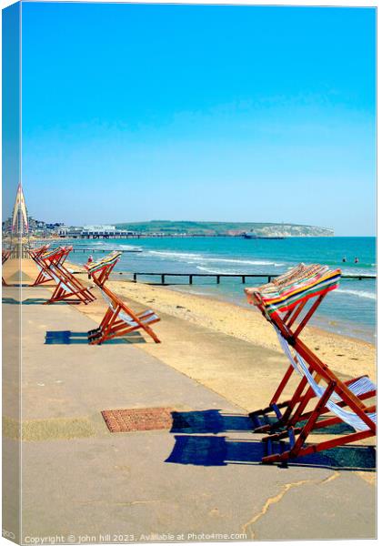 Early morning deckchairs at Sandown bay, Isle of Wight. Canvas Print by john hill