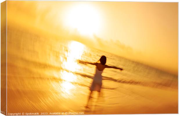 Motion blur Asian woman walking in ocean waves Canvas Print by Spotmatik 