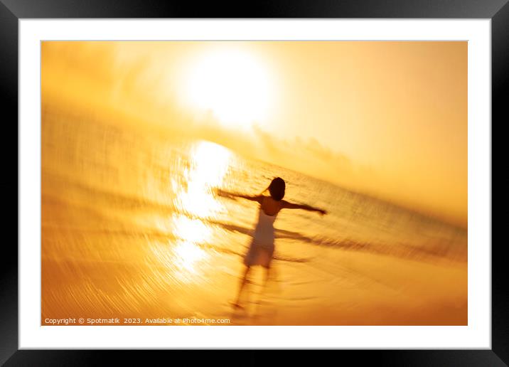 Motion blur Asian woman walking in ocean waves Framed Mounted Print by Spotmatik 