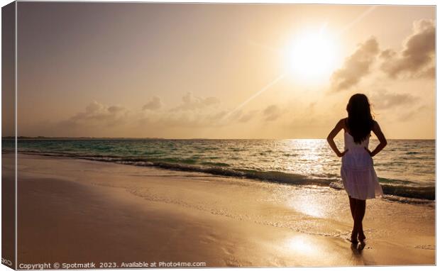 Young Asian girl in white dress by ocean Canvas Print by Spotmatik 