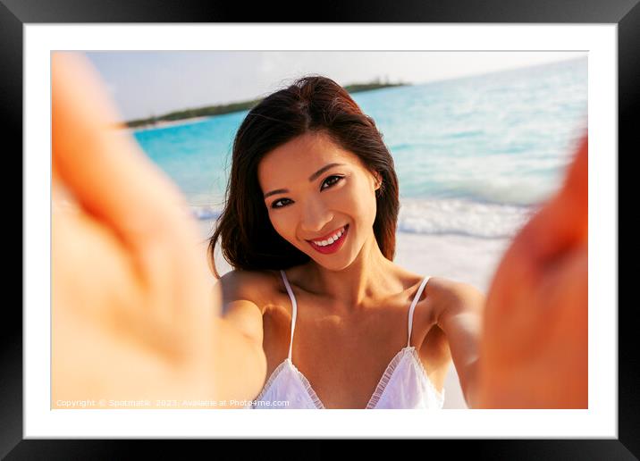 Portrait of beautiful Asian girl smiling by ocean Framed Mounted Print by Spotmatik 