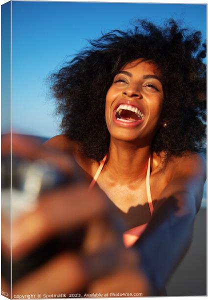 Laughing African American woman taking selfie on beach Canvas Print by Spotmatik 