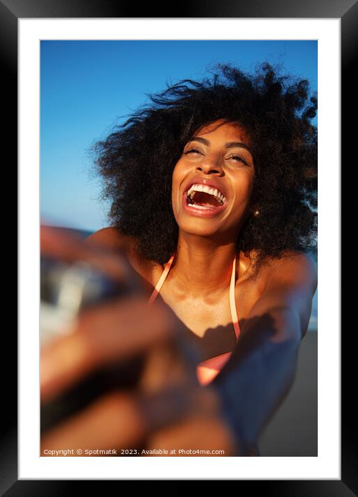 Laughing African American woman taking selfie on beach Framed Mounted Print by Spotmatik 