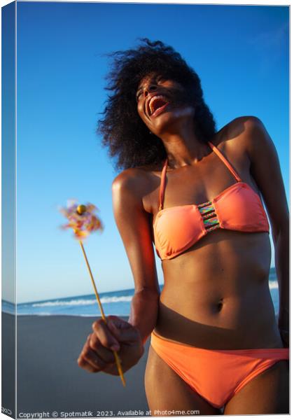 Young African American female having fun on beach Canvas Print by Spotmatik 