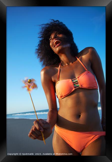 Young African American female having fun on beach Framed Print by Spotmatik 