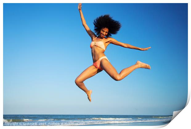 Fun loving Afro female jumping by the ocean Print by Spotmatik 