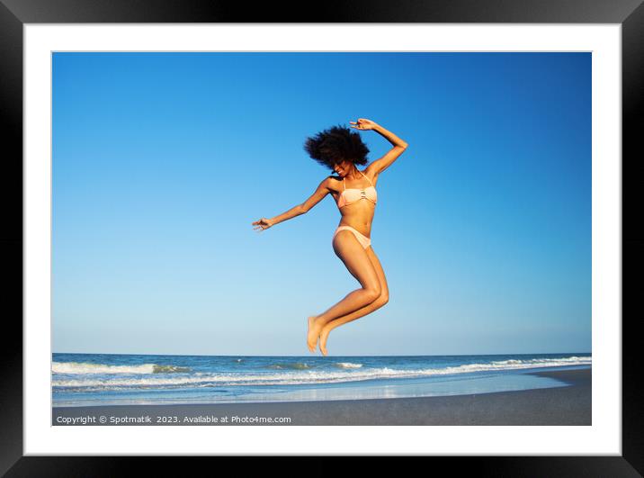 Afro American woman jumping for joy on beach Framed Mounted Print by Spotmatik 