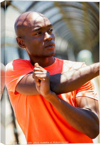 African American man stretching before outdoor sports activity Canvas Print by Spotmatik 