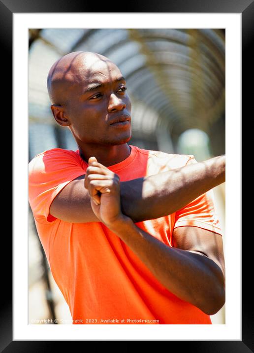 African American man stretching before outdoor sports activity Framed Mounted Print by Spotmatik 