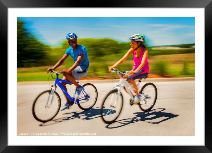 African American couple keeping fit riding bikes together Framed Mounted Print by Spotmatik 