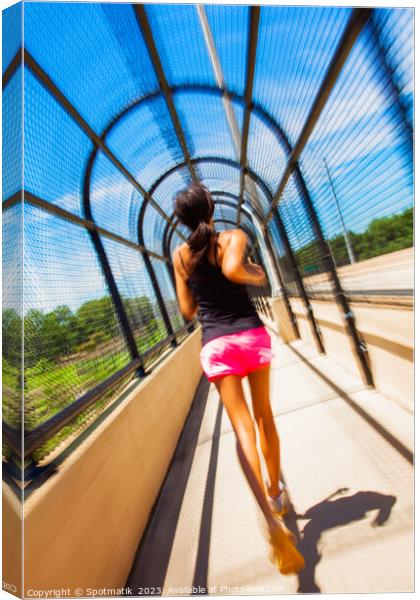 Young African American female jogging along arched walkway Canvas Print by Spotmatik 