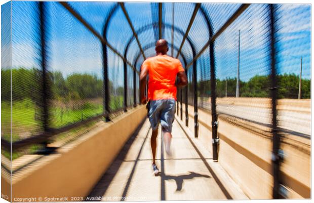 Solo African American man running through covered walkway Canvas Print by Spotmatik 