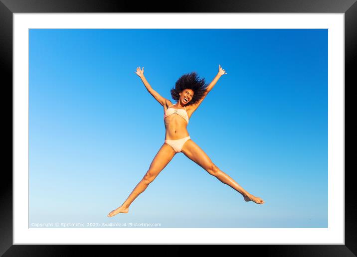 Carefree young African American woman jumping in swimwear Framed Mounted Print by Spotmatik 