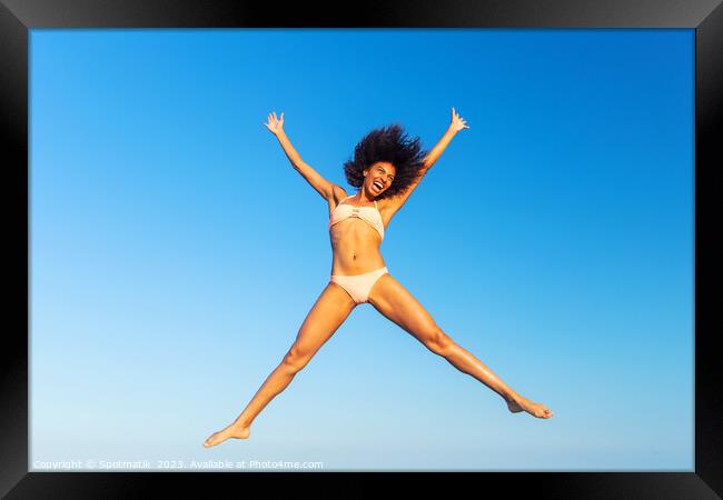 Carefree young African American woman jumping in swimwear Framed Print by Spotmatik 