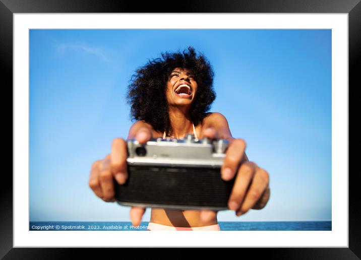 Laughing Afro American girl taking selfie on beach Framed Mounted Print by Spotmatik 