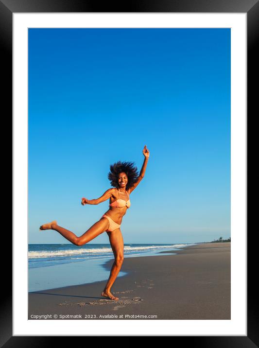 Playful young Afro American woman by the ocean Framed Mounted Print by Spotmatik 