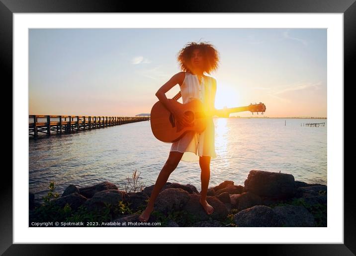Afro American girl playing guitar with ocean sunset Framed Mounted Print by Spotmatik 