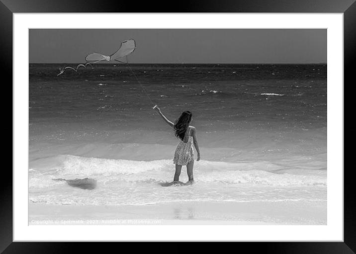 Tropical ocean view with young woman flying kite Framed Mounted Print by Spotmatik 