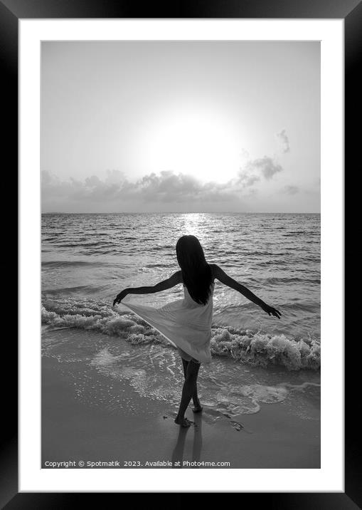 Asian girl with arms outstretched by the ocean Framed Mounted Print by Spotmatik 