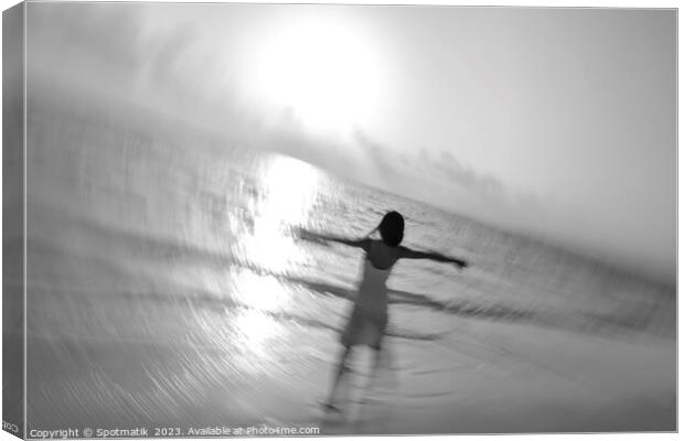 Motion blur carefree Asian female dancing on shoreline Canvas Print by Spotmatik 