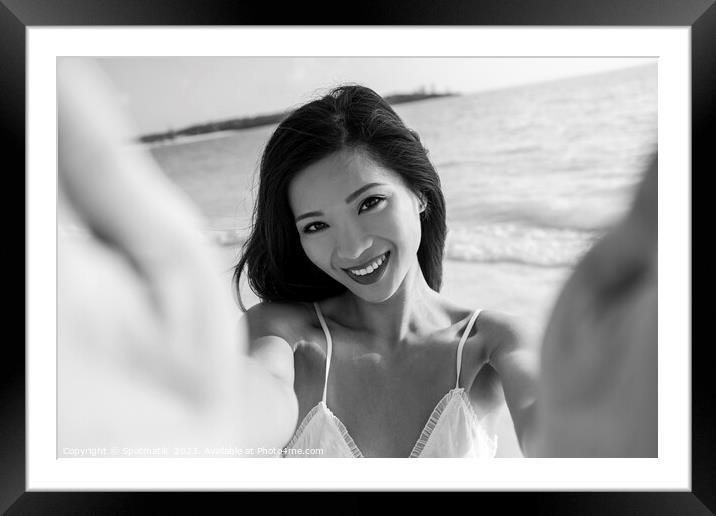 Outdoor portrait of smiling Asian female reaching out Framed Mounted Print by Spotmatik 