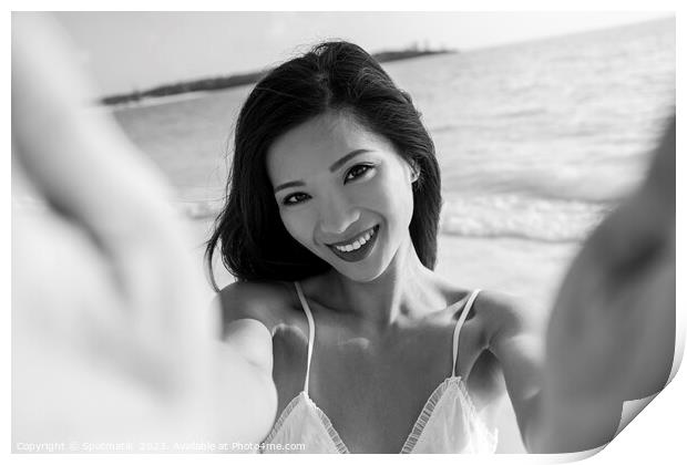 Outdoor portrait of smiling Asian female reaching out Print by Spotmatik 