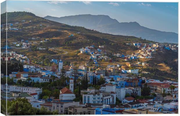 Wonderful Blue City with Mountains of Chefchoueon, Morocco Canvas Print by Maggie Bajada