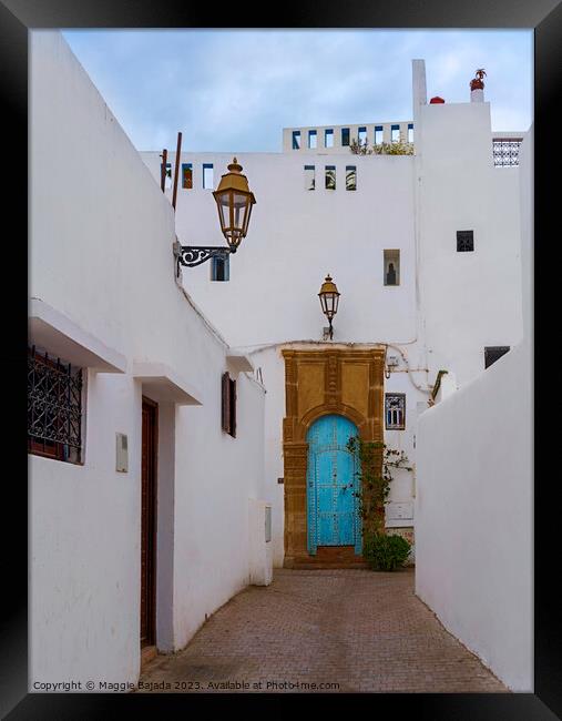 White Building with Blue Door in Rabat, Morocco. Framed Print by Maggie Bajada