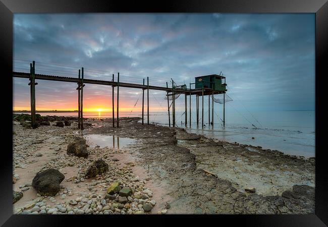 Sunset over fishing carrelets at Marsilly  Framed Print by Helen Hotson