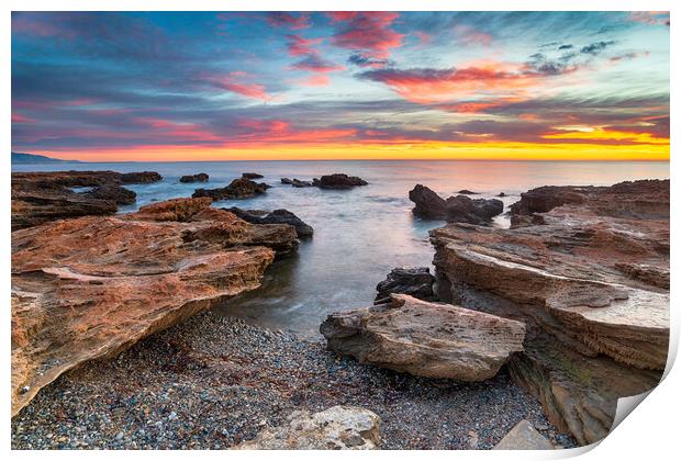 Stunning sunrise over the beach and rocks at Torre de la Sal  Print by Helen Hotson