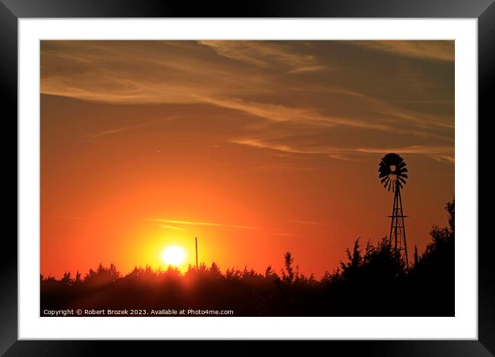 Sunset with an orange sky and Windmill silhouette Framed Mounted Print by Robert Brozek