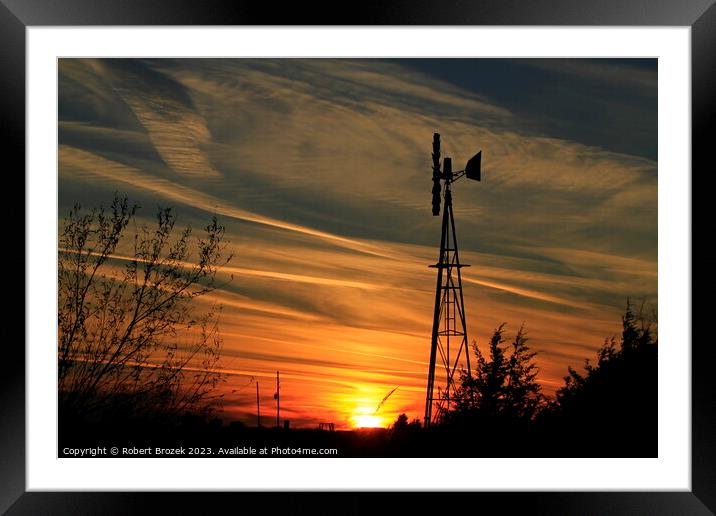 Sunset with an orange sky and Windmill silhouette Framed Mounted Print by Robert Brozek