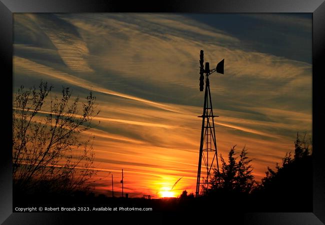 Sunset with an orange sky and Windmill silhouette Framed Print by Robert Brozek