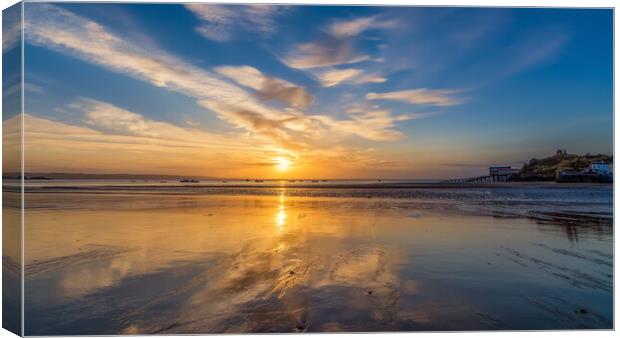 Sunrise reflections at low tide at Tenby in Wales Canvas Print by Tim Hill