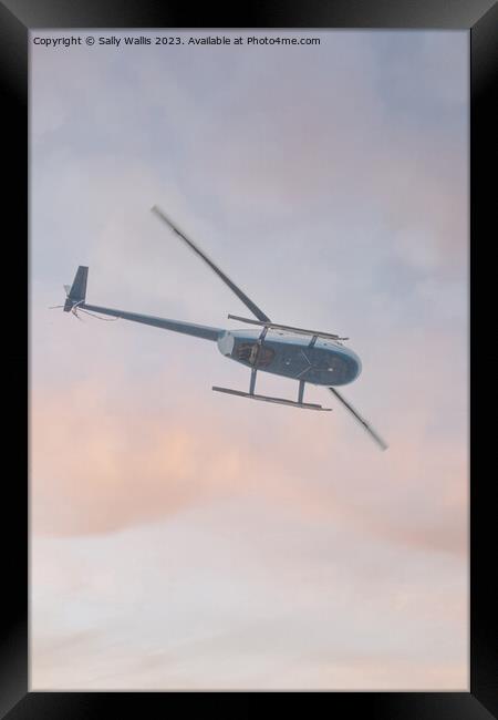 Helicopter flying  Framed Print by Sally Wallis