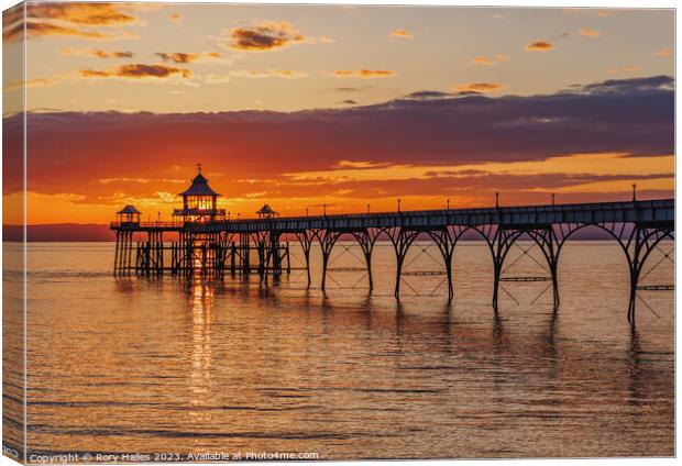 Clevedon Pier at sunset with a streak of sunlight going through the pier head Canvas Print by Rory Hailes