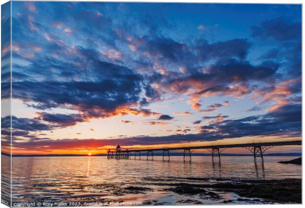 Clevedon Pier with a golden horizon and a streak of sunlight Canvas Print by Rory Hailes