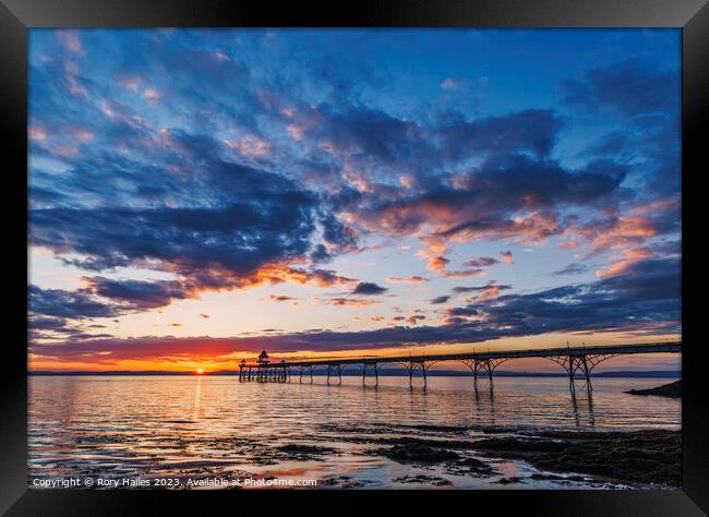 Clevedon Pier with a golden horizon and a streak of sunlight Framed Print by Rory Hailes