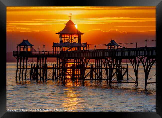 Clevedon at sunset with a streak of sunlight going through the pier head Framed Print by Rory Hailes