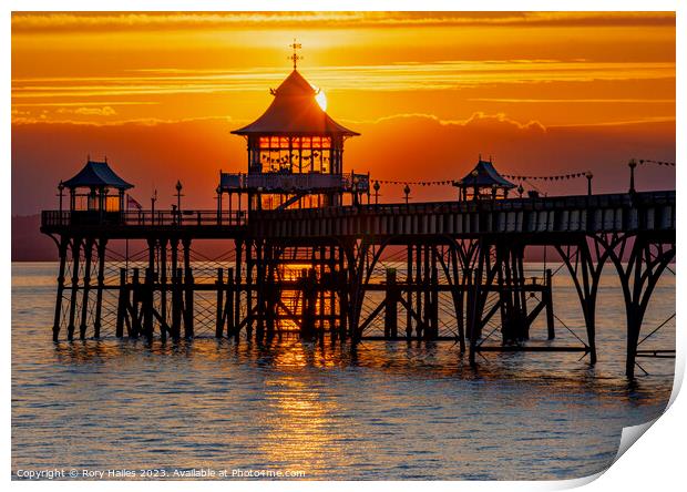 Clevedon at sunset with a streak of sunlight going through the pier head Print by Rory Hailes