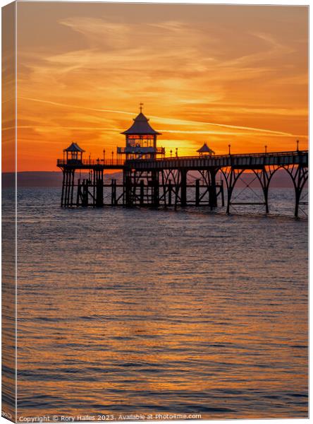 Clevedon pier at sunset with a reddish orangey glow Canvas Print by Rory Hailes