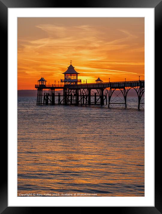 Clevedon pier at sunset with a reddish orangey glow Framed Mounted Print by Rory Hailes
