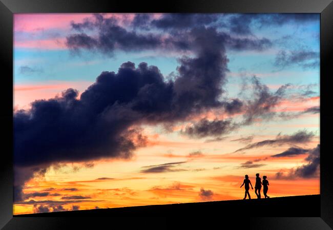 Silhouettes of three girls walking in the sunset Framed Print by Fabrizio Troiani
