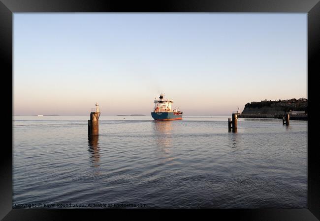 Cargo ship departs Framed Print by Kevin Round