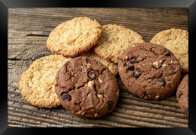 Various tasty cookies biscuits on wooden background Framed Print by Lubos Chlubny