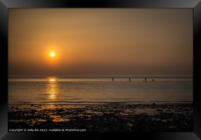 Sunset Paddle Boarders Framed Print by Kelly Rix
