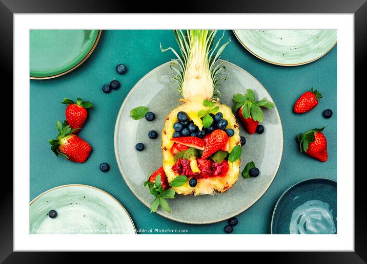 Fruit salad in half a pineapple. Framed Mounted Print by Mykola Lunov Mykola