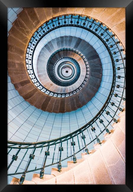 Spiral stairs and blue opaline inside the lighthouse Framed Print by Laurent Renault
